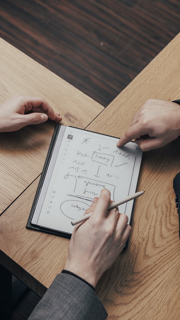 Zwei Steuerberater schauen sich ein Schaubild auf einem Tablet an